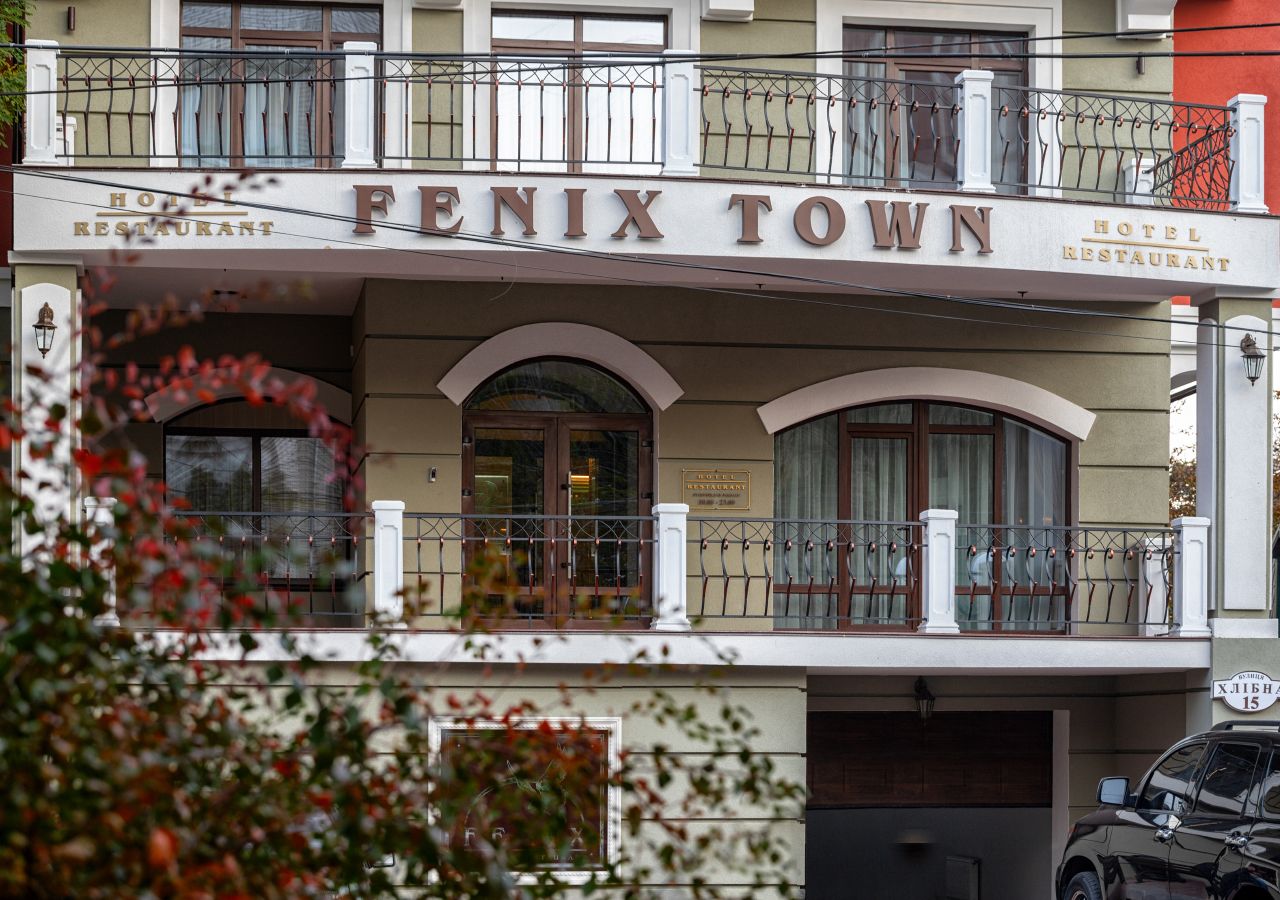 A hotel with a sign reading "FENIX TOWN HOTEL RESTAURANT."