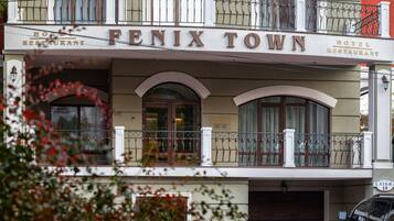 A hotel with a sign reading "FENIX TOWN HOTEL RESTAURANT."