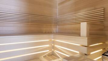 A modern interior with wooden slatted ceilings and illuminated ledges.