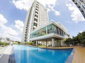 A modern building with a swimming pool in front. - Your Dream Home at Abreeza Davao (Davao)