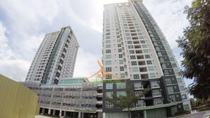 A modern high-rise residential building with multiple balconies and a central courtyard. - Your Dream Home at Abreeza Davao (Davao)