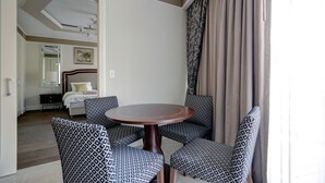 A hotel room with a round table, patterned chairs, a bed, and a large window with curtains. - ⚜WALDORF ASTORIA⚜ King Suite ⚜Luxury 1 BR+ balcony (Jerusalem)