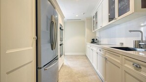 A modern kitchen with stainless steel appliances, white cabinetry, and a tiled backsplash. - ⚜WALDORF ASTORIA⚜ King Suite ⚜Luxury 1 BR+ balcony (Jerusalem)