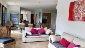 A spacious living area with a sofa set, a dining table with chairs, and a kitchen in the background. - PRETTY NEW AIR CONDITIONED VILLA WITH HEATED POOL IN THE CAMPAIGN OF UZES (UZES)