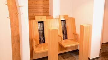 A modern bathroom with wooden benches and a wooden wall panel.