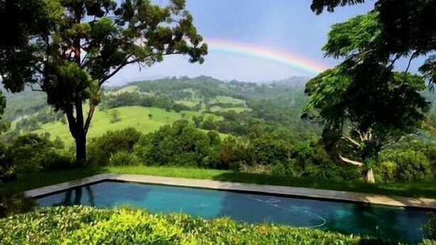 A swimming pool surrounded by lush greenery and hills. - "Riverbend Suites" BYRON Hinterland Retreat (Rosebank)