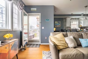 A living room with a sofa, a coffee table, and a view of the outside. - Pool! Out of HGTV! Linens, Bikes, Beach gear, elev, oceanview, luxury! (Wildwood Crest)