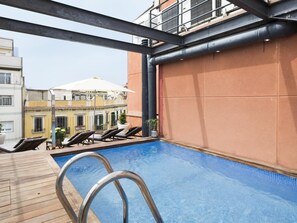 A rooftop pool with metal railings, lounge chairs, and potted plants. - My Space Barcelona Loft near the Arc de Triomphe with pool and terrace (Barcelona)