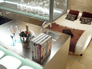 A kitchen area with a sink, a wine cooler, and a glass display case. - My Space Barcelona Loft near the Arc de Triomphe with pool and terrace (Barcelona)