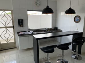 Elite Quadruple Room | Private kitchen | Fridge, microwave, coffee/tea maker