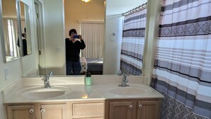 A bathroom with two sinks, a mirror, and a shower curtain. - Serenity in Sunny Arizona with tons of birds and shade trees!  Bike Trail Galore (Tubac/Rio Rico)