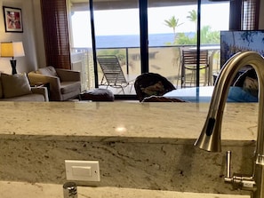Enjoy a comfortable stay in this stylish room with a sofa, armchairs, and a balcony offering ocean views.