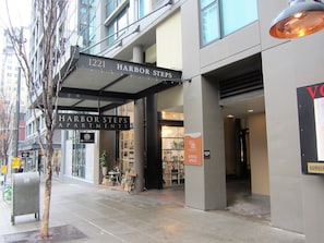 Harbor Steps Apartments offers a modern entrance with a large overhang and large windows.