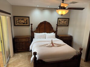 Classic four-poster bed and elegant furnishings create a serene retreat.