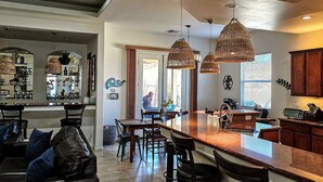 Una cocina moderna con una isla central, iluminación colgante y armarios de madera.