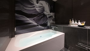 A modern bathroom with a large bathtub, dark wood paneling, and a wall mural. - HOTEL BAMBOO GARDEN Shin-Yokohama - Adults Only (Yokohama)