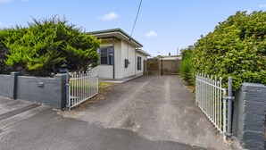 A residential property with a paved driveway, a gated entrance, and a house with a light-colored exterior. - Comfort on Crouch- Enjoy this beautiful house right in CBD.  (Mount Gambier)