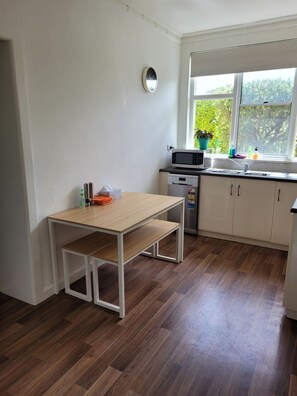 NEW - Kitchen bench has been removed and a kitchen table with bench seats added.