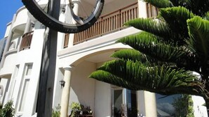 A building with a large, ornate bicycle sculpture in front. - Summer Time B&B (Magong)