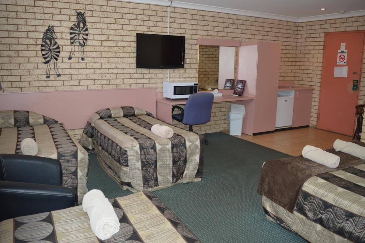 Deluxe Quadruple Room (1 queen and 3 single beds) | Blackout curtains, soundproofing, iron/ironing board, free WiFi