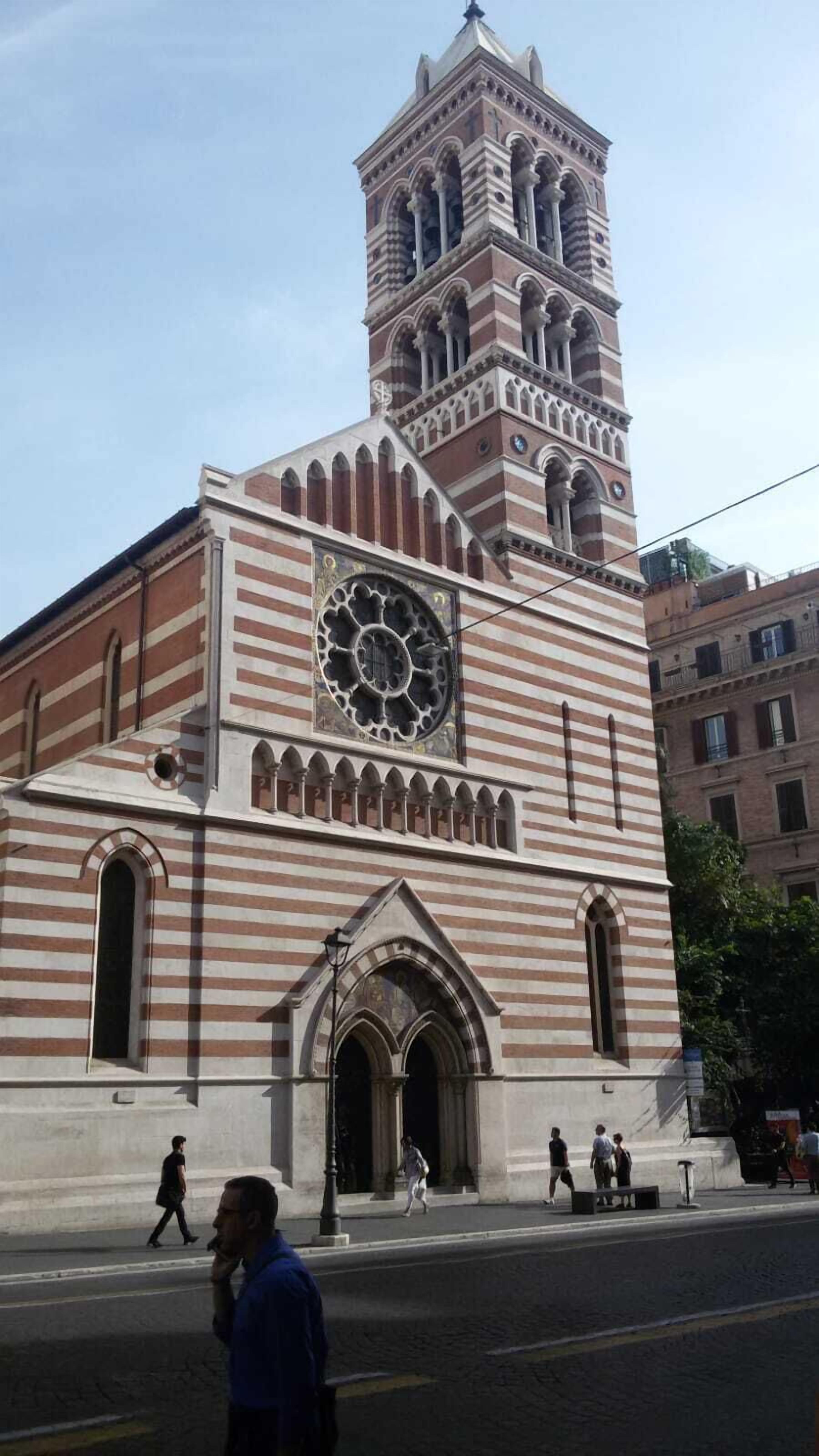 A historic building with a prominent clock tower and arched windows.