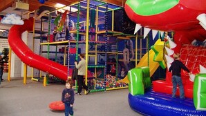 A play area with a climbing structure, slides, and inflatable play equipment. - Motel Drei König (Heimsheim)