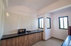 Deluxe Room | Private kitchen | Full-size fridge, microwave, oven, stovetop - Rajmandir Holiday Home (Udaipur)