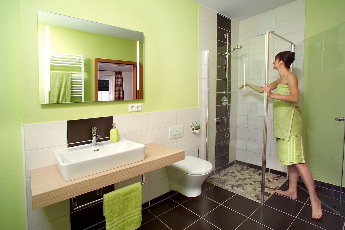 A bathroom with a sink, toilet, and shower.