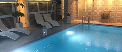 Indoor pool, open 8:00 AM to 9:00 PM, pool loungers