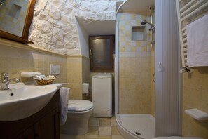 A bathroom with a sink, toilet, and shower. - Trulli San Leonardo (Alberobello)