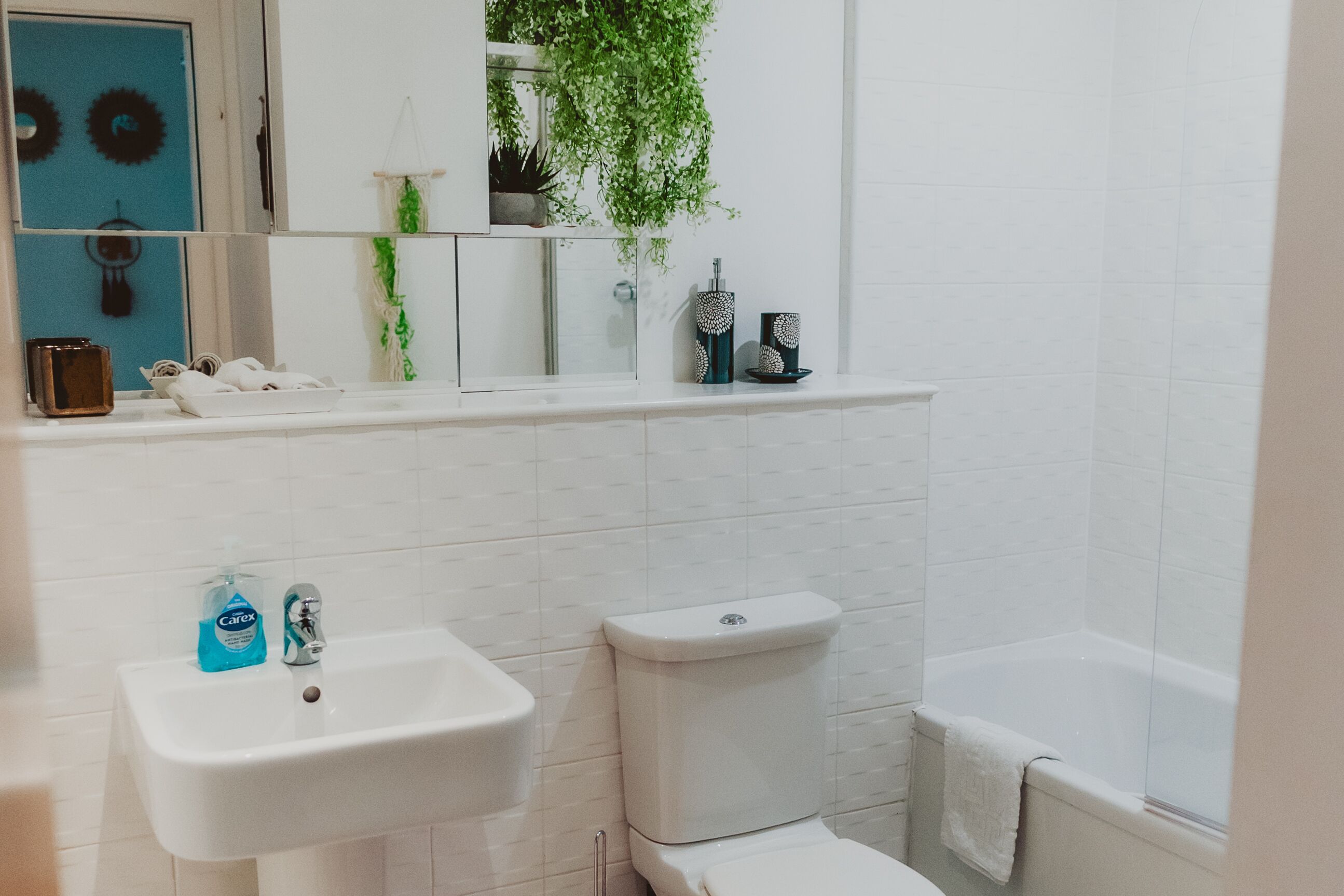 A bathroom with a sink, toilet, and bathtub.