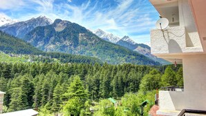 A mountain view from a balcony with a satellite dish and a small balcony area. - Hotel Monarch Residency (Manali)
