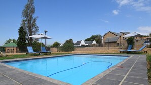 Outdoor pool, open 8:00 AM to 7:00 PM, pool umbrellas, pool loungers - Kyalami Creek Luxury Apartments (Midrand)