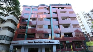 A multi-story building with a sign for Hotel Eastern Residence.