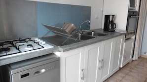 A kitchen with a gas stove, a coffee maker, and a dishwasher. - House near the African reserve (Sigean)