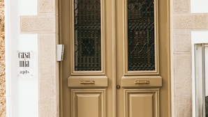 A double door with a textured wall and a sign reading "casa mia apts". - Casa Mia Apartments (Agios Nikolaos)