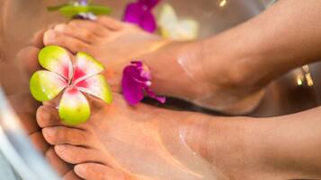 A foot soak with flowers and a foot massager.