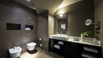 Ein modernes Badezimmer mit Waschbecken, Toilette und großem Spiegel.