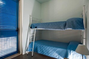 Cozy retreat with a bunk bed, bedside table, and ladder for easy access.