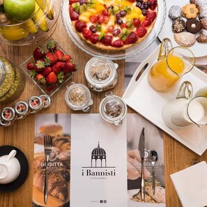 A breakfast setting with a variety of foods including a fruit tart, strawberries, and pastries. - B&B I Bannisti (Santeramo in Colle)