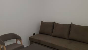 Apartamento, 1 quarto | Área de estar | TV de tela plana