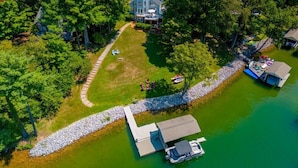 An aerial view of a lakeside property with a house, a dock, and a boat. - Hot Tub, Fireplace & Pet Friendly! Come Visit "Lake It or Knot"! (Huddleston)