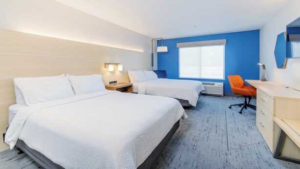 A hotel room with two beds, a desk, an orange chair, and a large window. - Holiday Inn Express & Suites Medford by IHG (Medford)