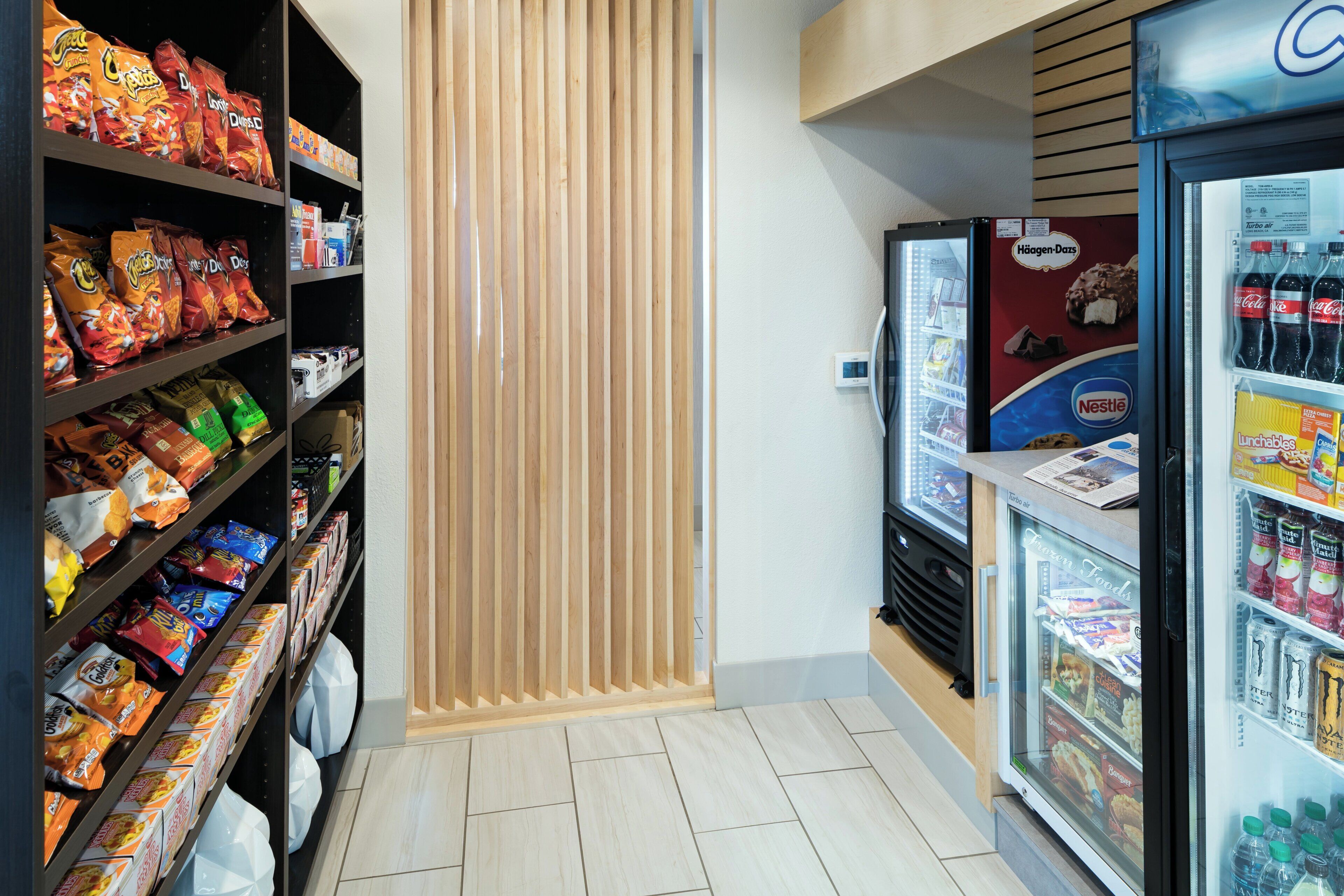 A snack and beverage vending area with various snack options and a refrigerated section with drinks.