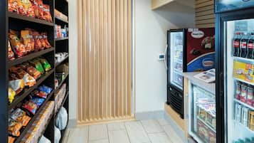 A snack and beverage vending area with various snack options and a refrigerated section with drinks.
