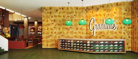 A shoe store with a wooden wall and a display of various sneakers.