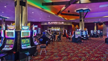 A casino floor with slot machines, a Players Club sign, and a patterned carpet.