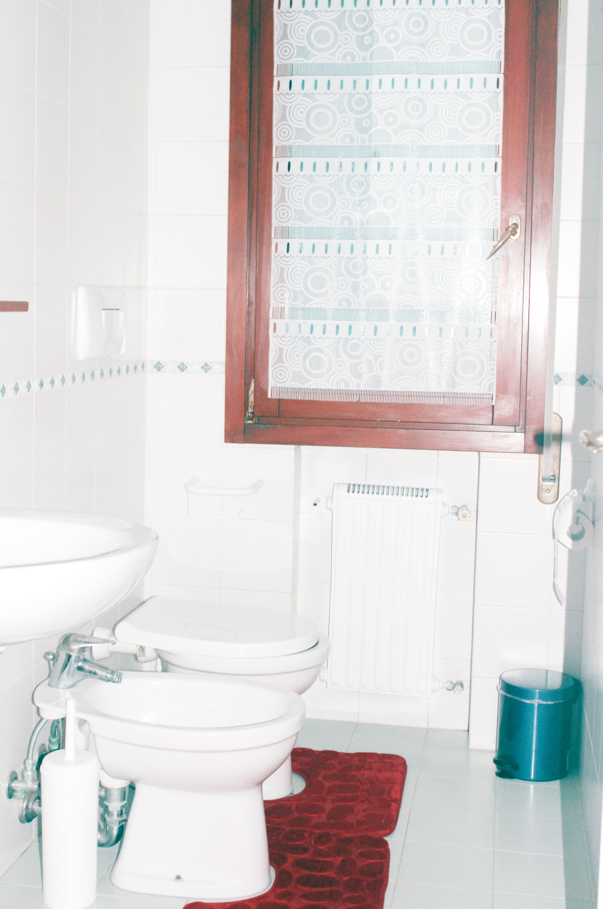 A bathroom with a toilet, bidet, and sink.