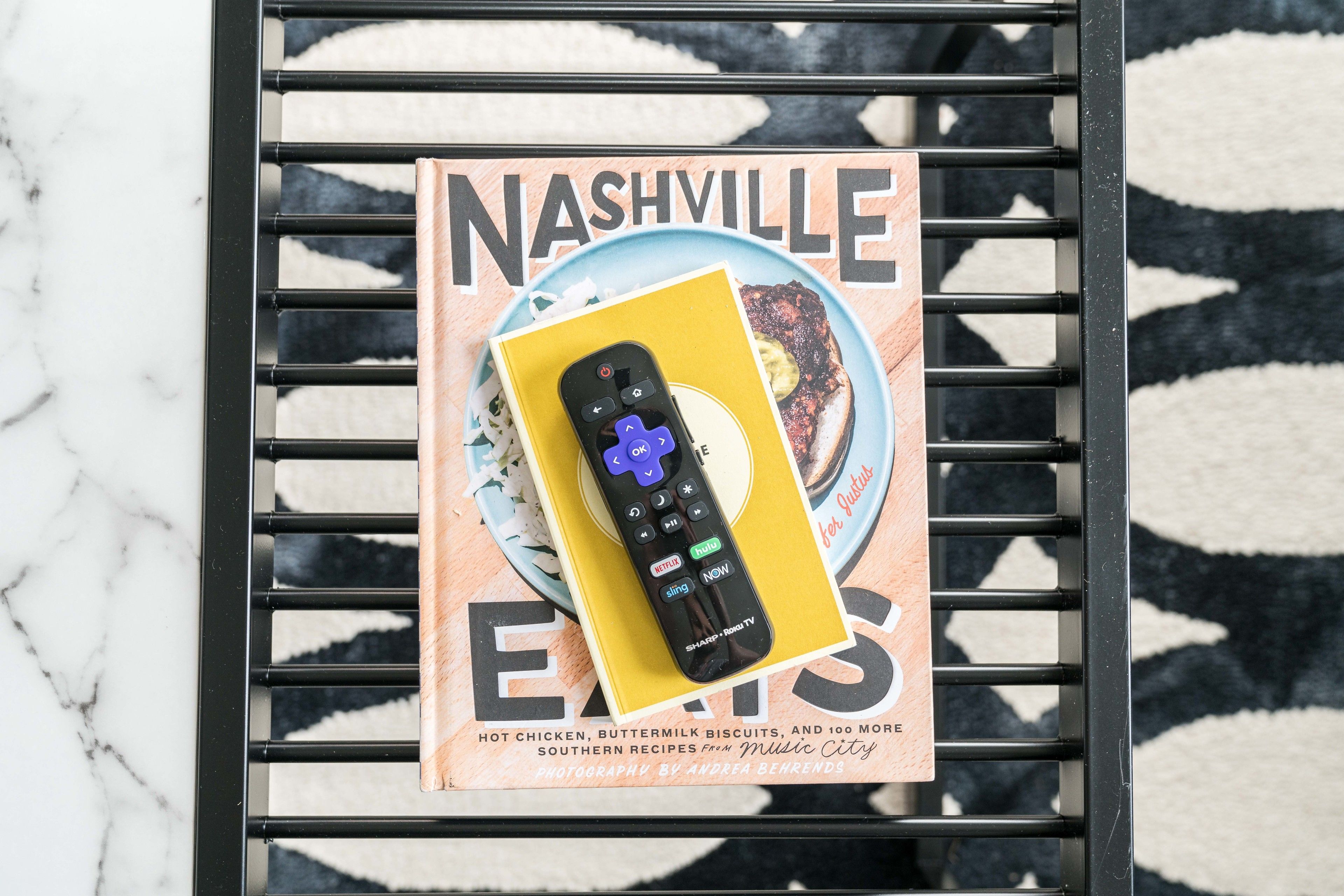 A magazine titled "Nashville Eats" with a remote control on top.
