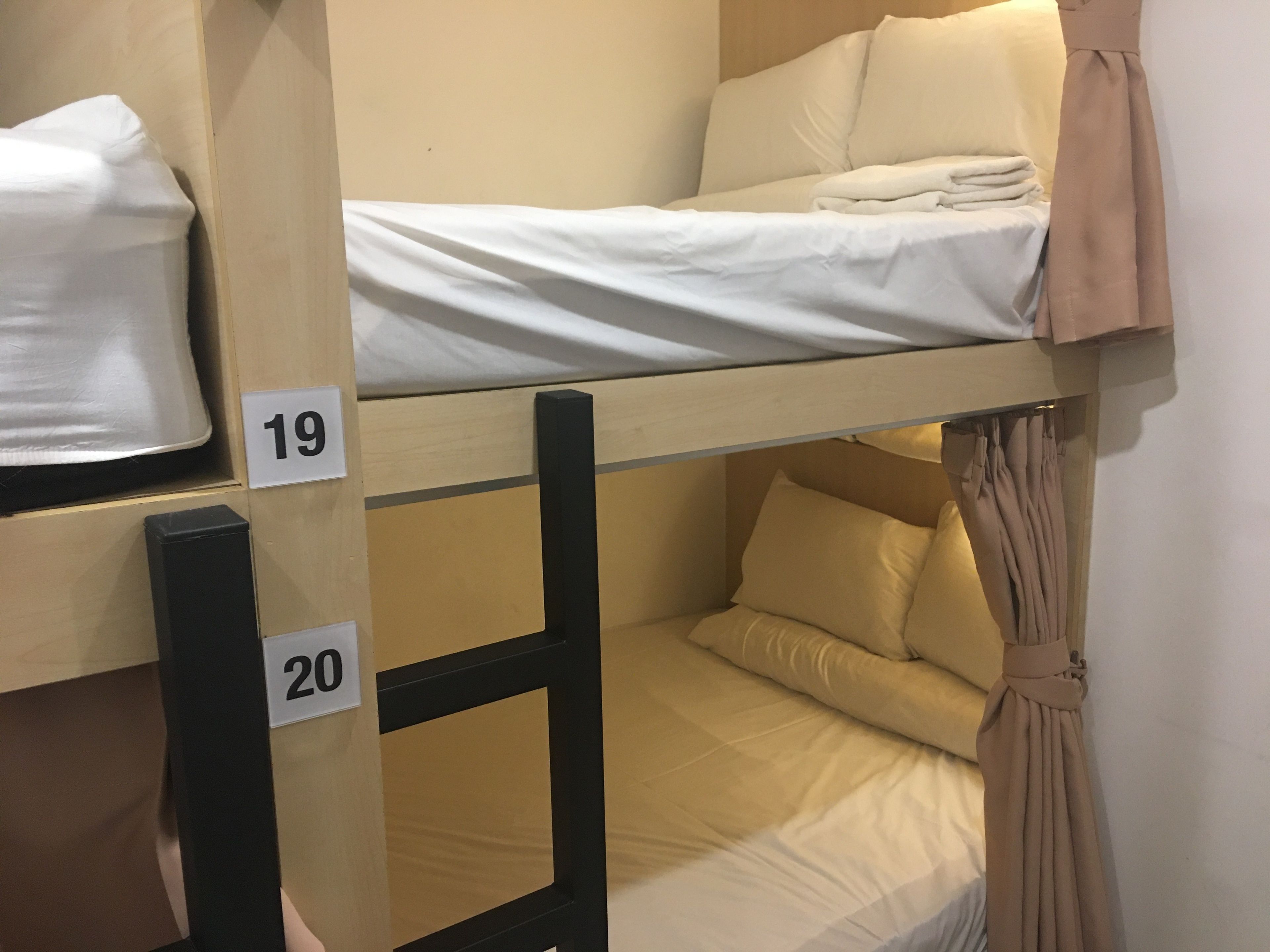 Bunk beds with numbers 19 and 20, each with pillows and a blanket.